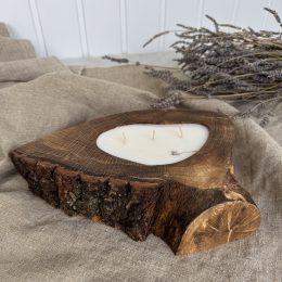 Handmade sandalwood soy candle in rustic oak wood with bark texture