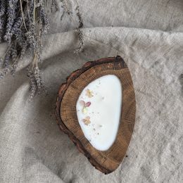 Handmade melon soy candle in rustic oak wood with bark texture