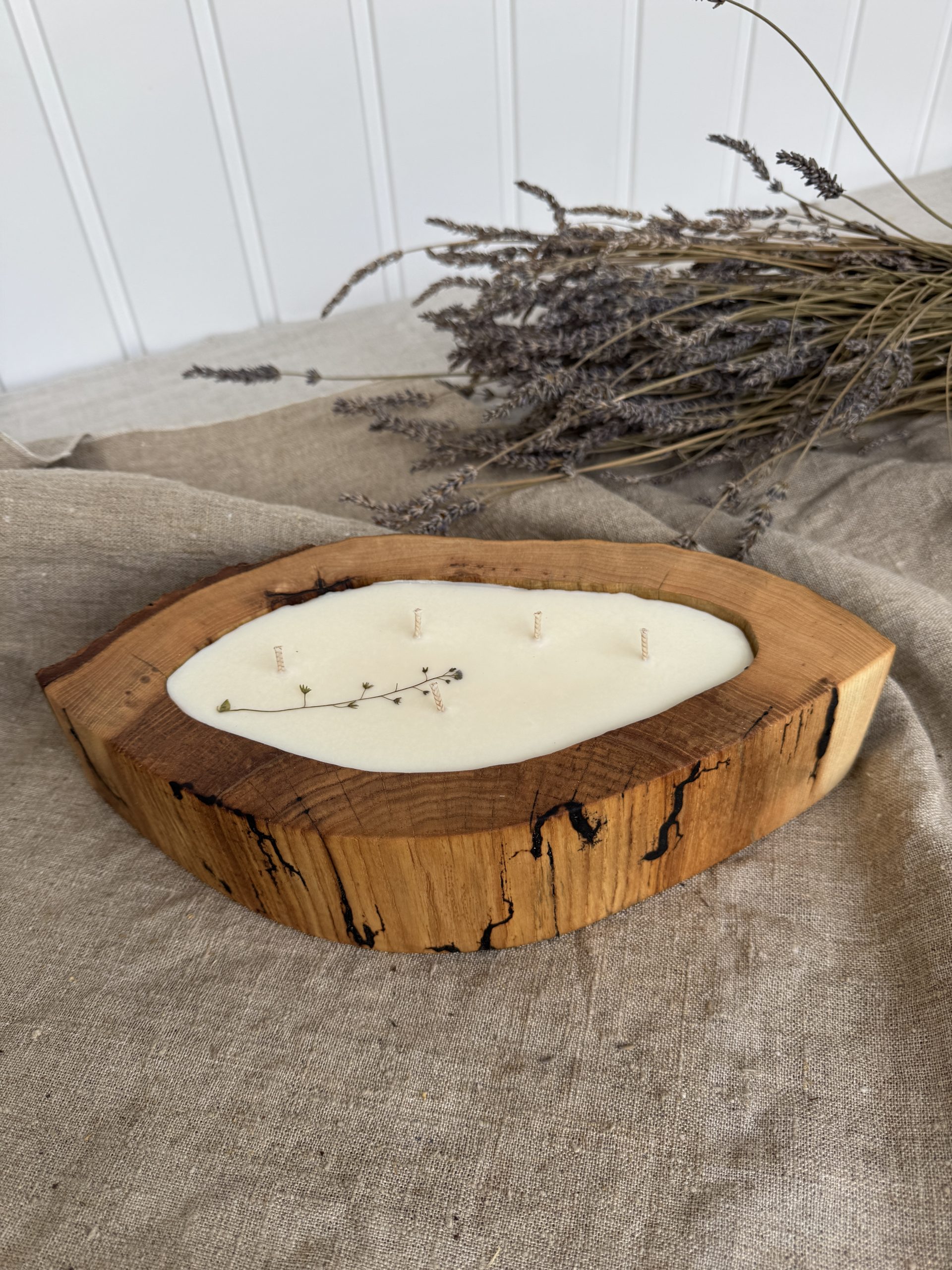 Large handmade coffee scented candle in textured ash wood vessel with natural spalting patterns and organic grain details