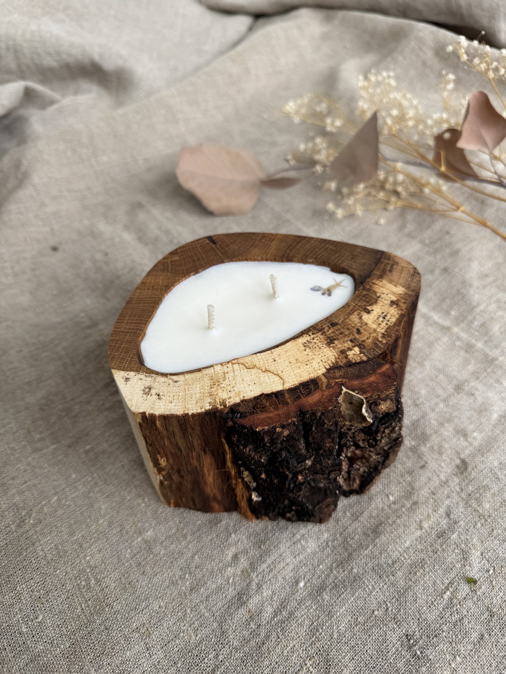 Handmade Melon soy wax candle in natural oak wood vessel with two cotton wicks and natural bark edge