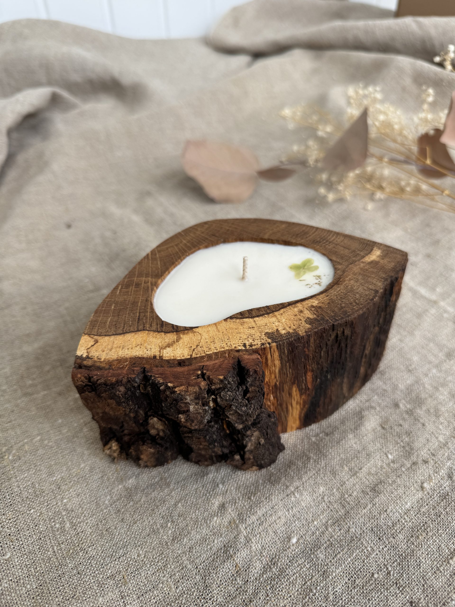 Handmade unscented soy wax candle in natural oak wood vessel with single cotton wick and natural bark edge