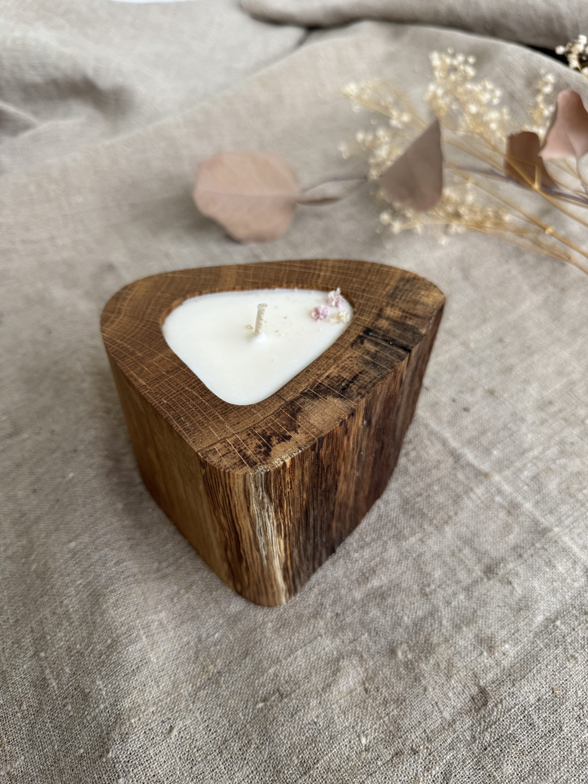 Handmade unscented soy wax candle in natural oak wood vessel with single cotton wick and natural wood grain