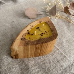 Handmade beeswax candle with propolis in natural ash wood vessel with two cotton wicks