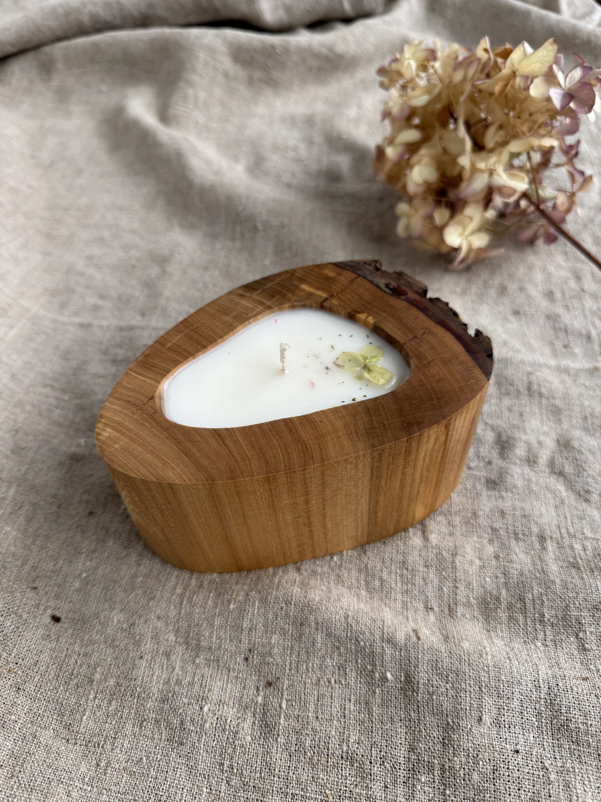 Handmade unscented soy wax candle in natural oak wood vessel with single cotton wick and natural oak grain