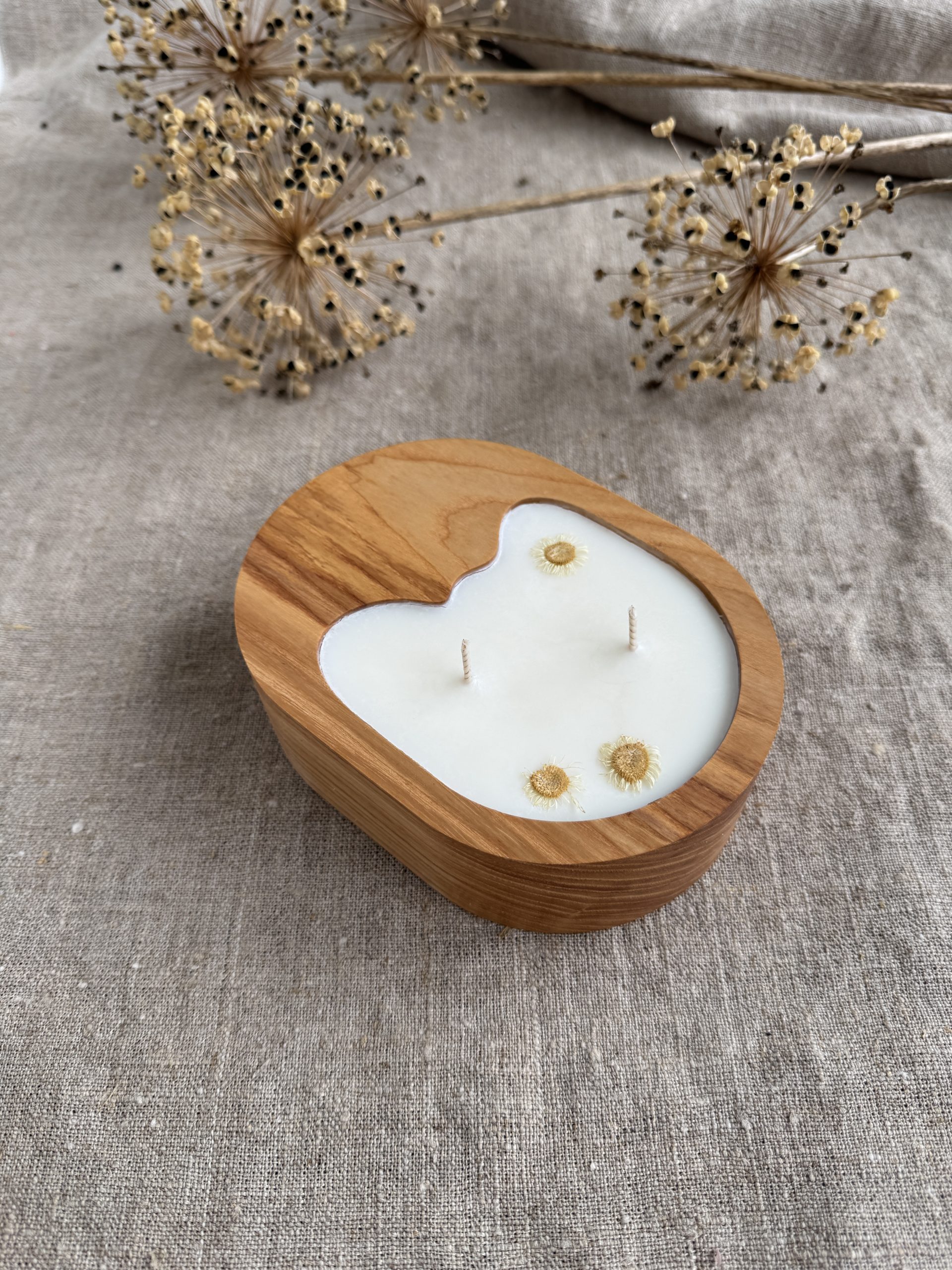 Handmade unscented soy wax candle in natural ash wood vessel with two cotton wicks and organic shape