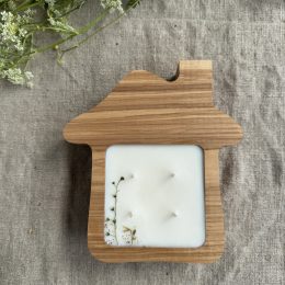 Handmade house-shaped ash wood soy candle with four cotton wicks and natural botanical decoration