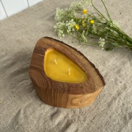 Handmade ash wood candle filled with natural beeswax in a unique triangular wooden vessel